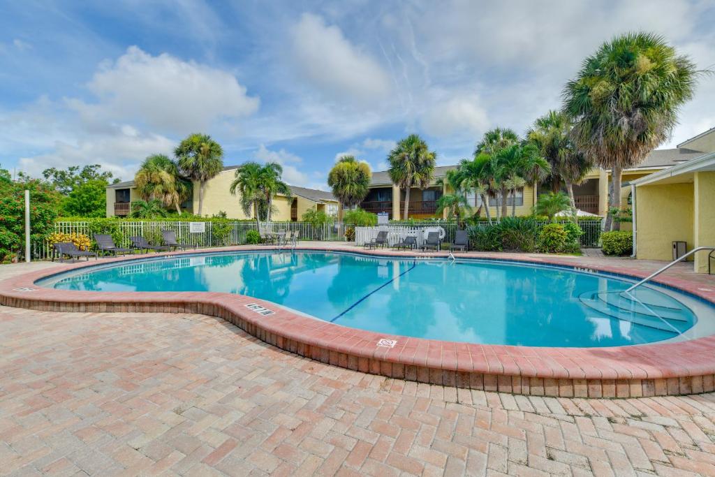 a large swimming pool with a brick pathway around it at 4 Mi to Siesta Key Beach Condo with Pool Access in Sarasota