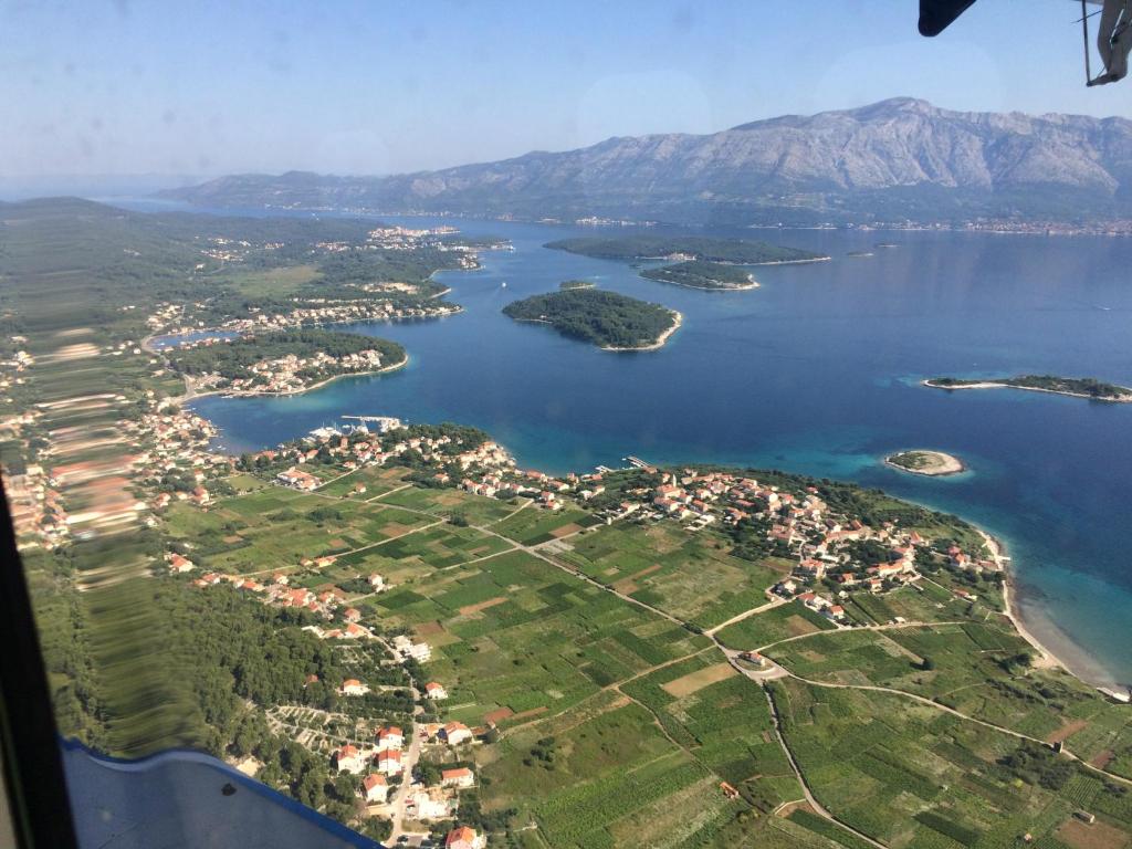 an aerial view of a lake with mountains in the background at Apartments Luka in Lumbarda
