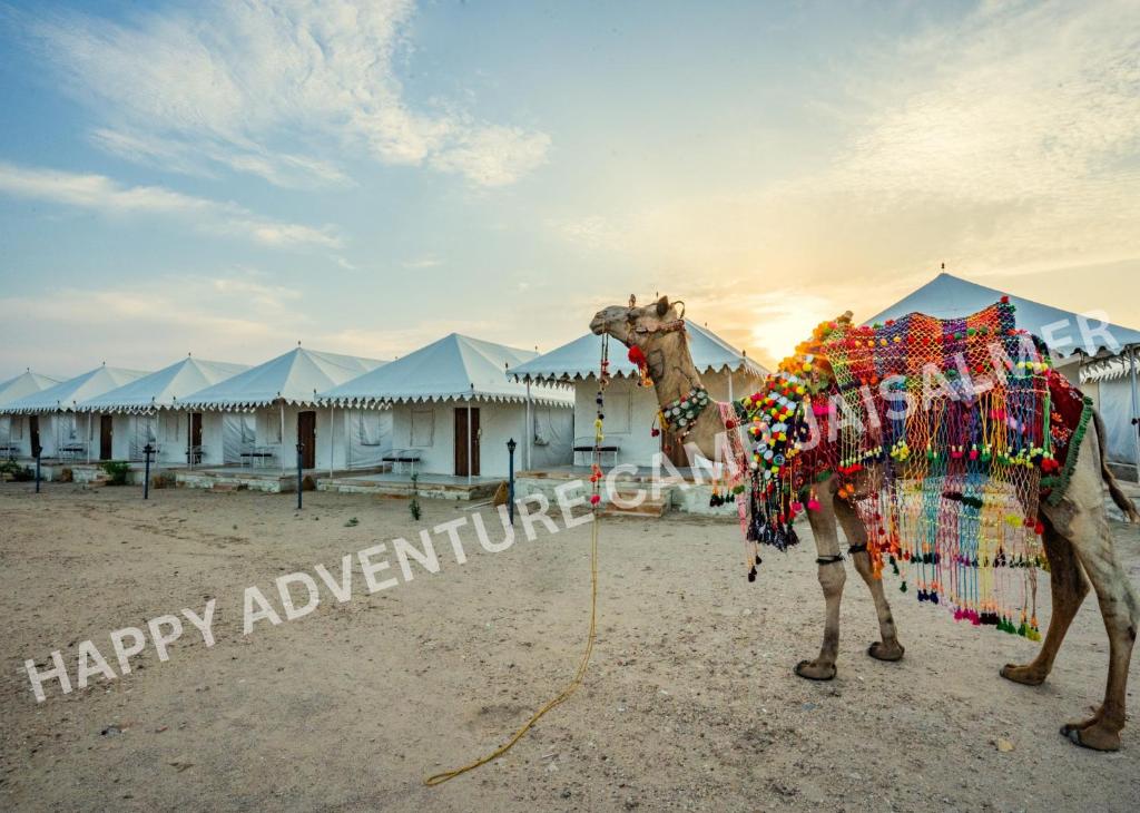 a statue of a camel in front of some tents at Happy Adventure Camp & Resort Sam Jaisalmer in Sām