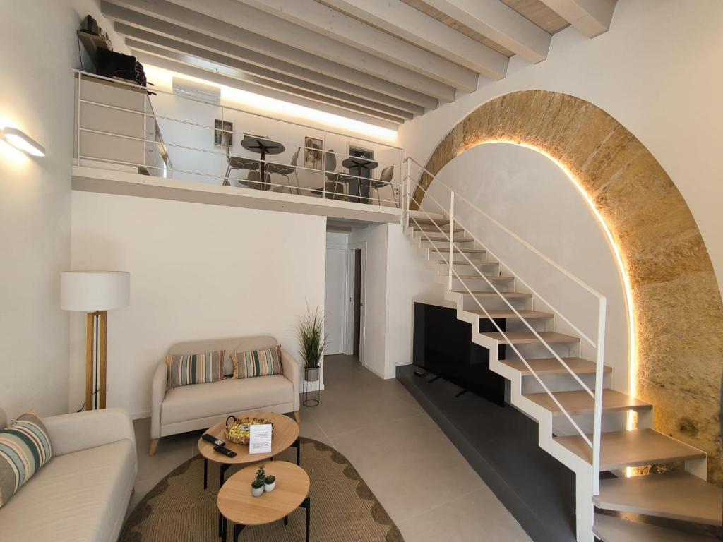 a living room with a spiral staircase in a building at Bed and Breakfast Nilu' in Castellammare del Golfo