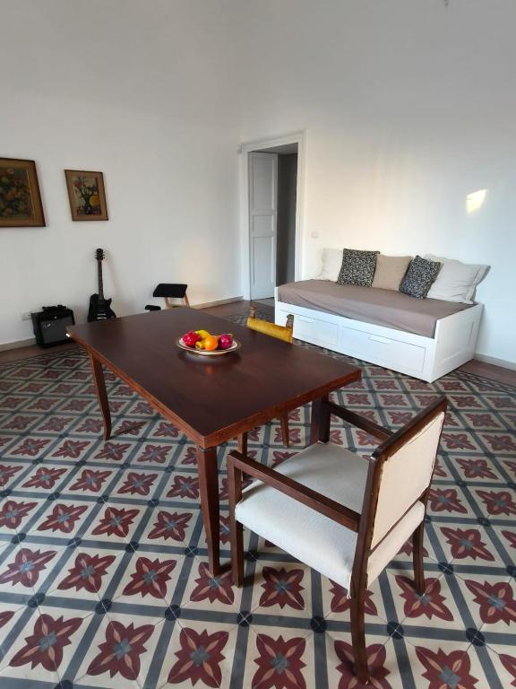 a living room with a table and a bed at Casa Ludovica in Catania