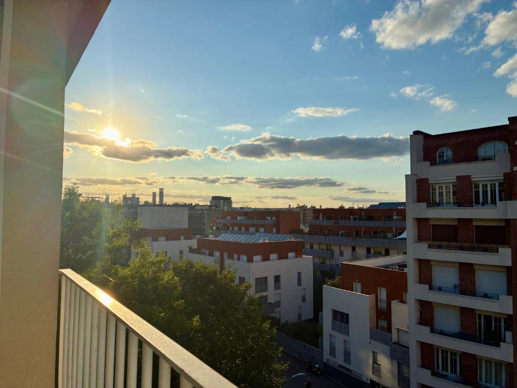 a view of the city from a balcony of a building at Studio lumineux, 10min de Paris in Issy-les-Moulineaux