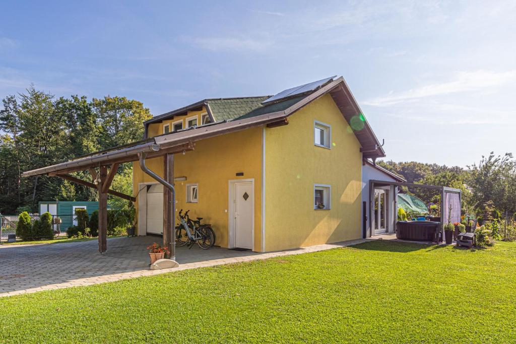 a small yellow house with a gazebo at Holiday Home Zala with Jacuzzi - Happy Rentals in Moravske Toplice