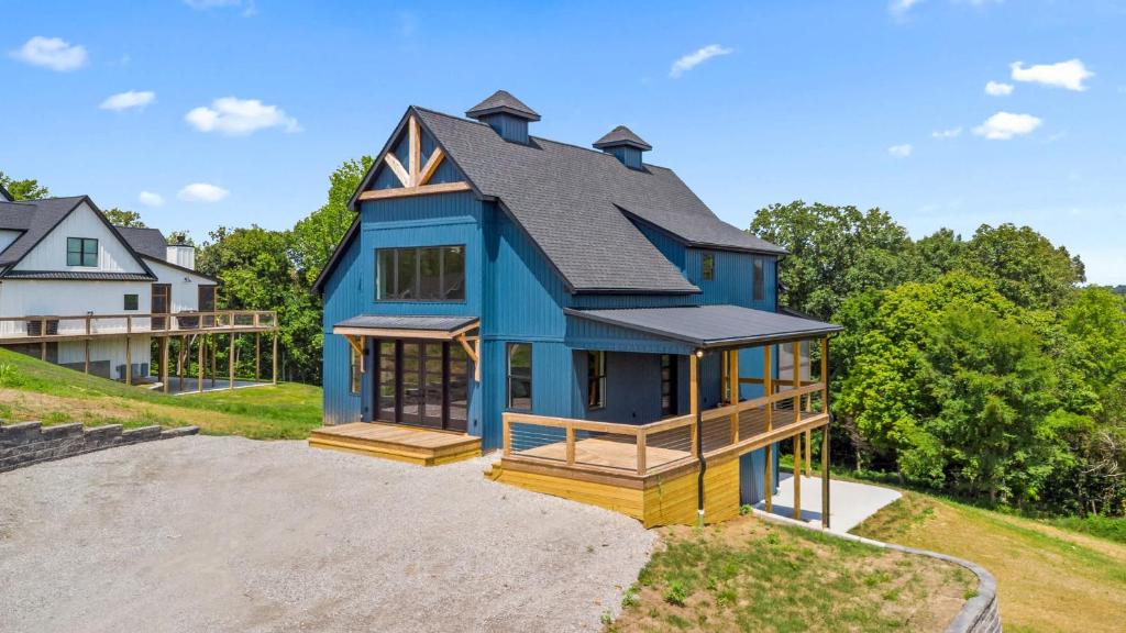 a blue house with a black roof at NEW Spacious Clarkson Getaway w Games & Yard in Clarkson