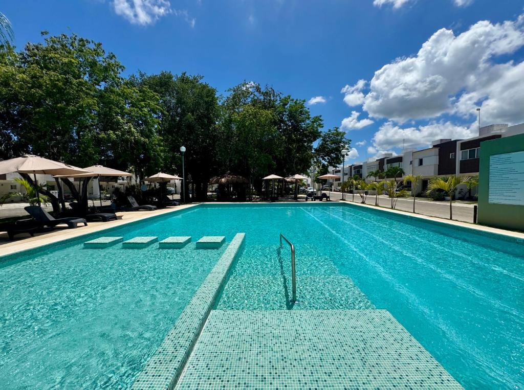 a swimming pool with blue water in a building at Casa Bella in Playa del Carmen