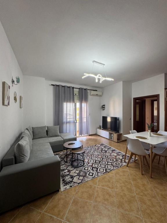 a living room with a couch and a table at Family Apartment 02 in Shkodër
