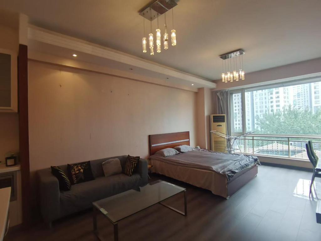 Ένα ή περισσότερα κρεβάτια σε δωμάτιο στο Apple Community North District Serviced Apartment