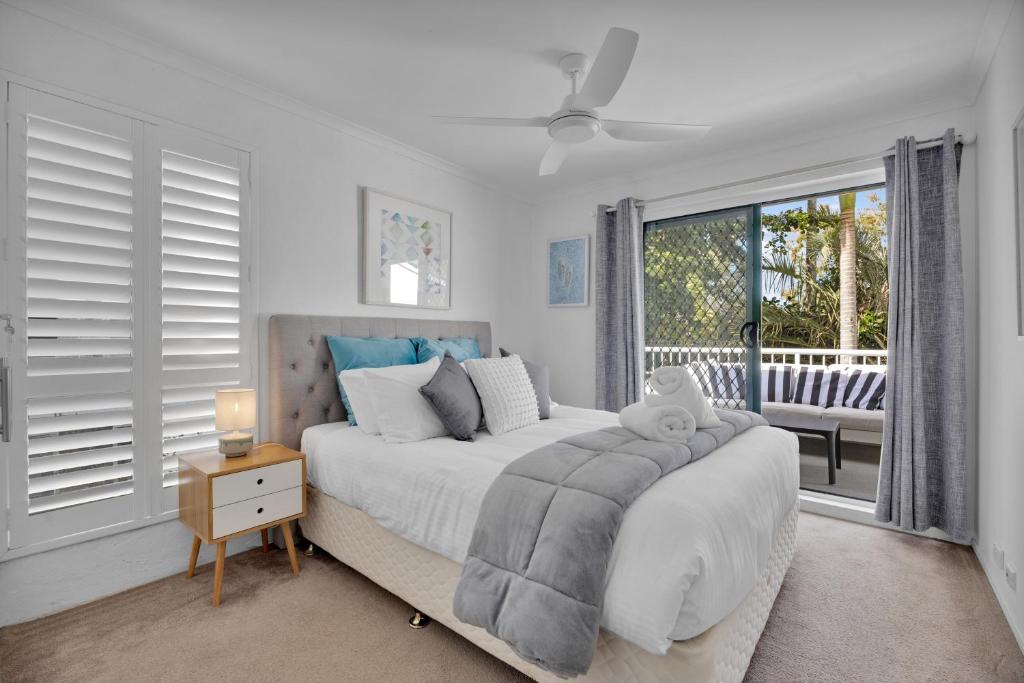a bedroom with a bed and a large window at A Noosa River gem, central and family friendly in Noosaville