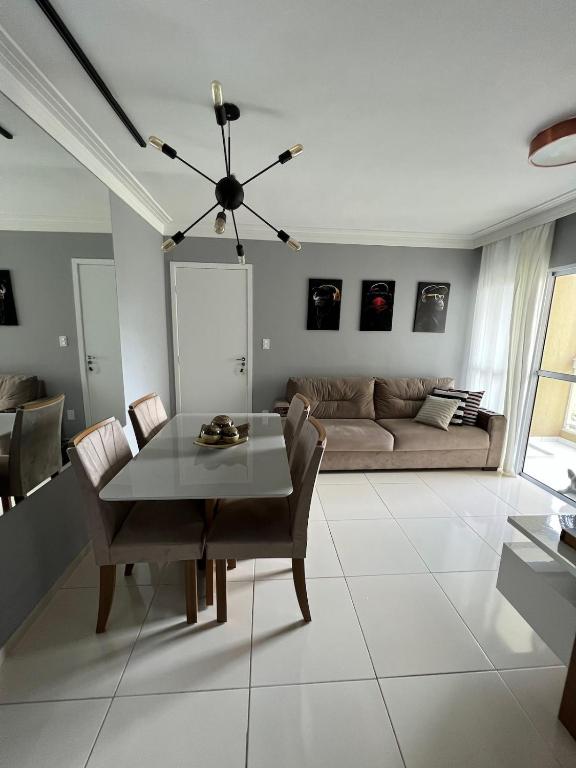 a living room with a table and a couch at Apartamento próximo a Orla de Atalaia in Aracaju