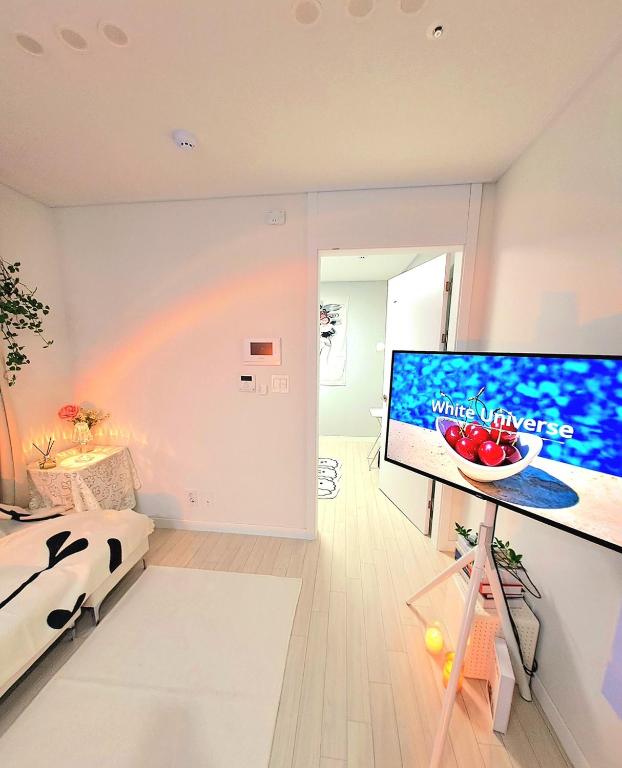 a room with a large television with a rainbow on the wall at Gongrim Stay in Seoul