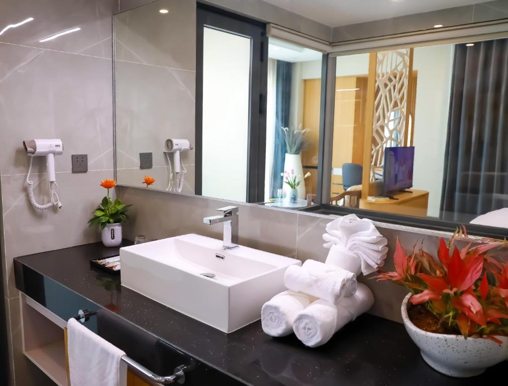 a bathroom with a sink and a mirror at Daystar Hotel in Phú Quốc