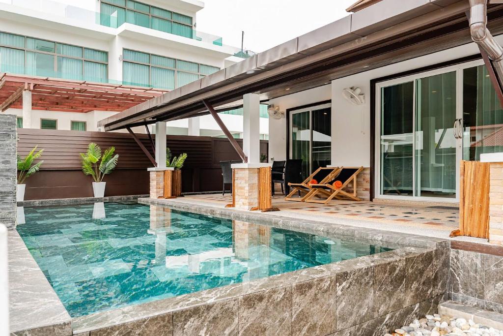 a swimming pool in front of a house at Cozy Pool Villa near Kamala - 850 meter to the beach in Kamala Beach