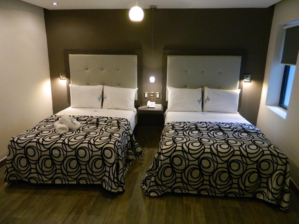 Postel nebo postele na pokoji v ubytování Hotel Flamingo Merida