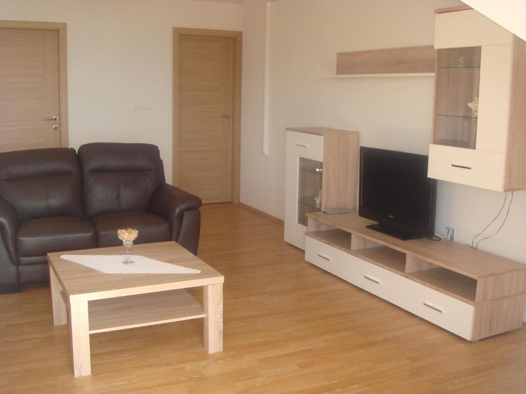 a living room with a couch and a coffee table at Apartments Jelicic in Selce