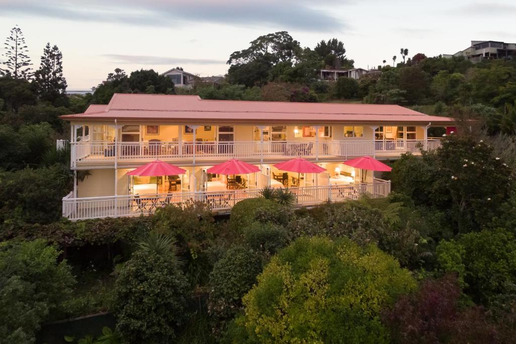 a large building with red umbrellas on a hill at Bellrock Lodge in Russell