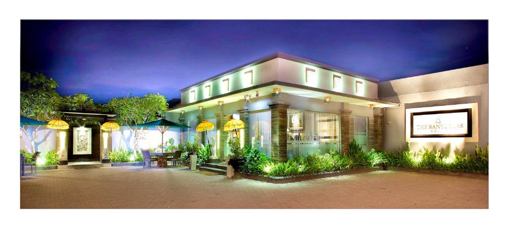 a large white building with a lot of windows at The Banyumas Villa in Denpasar