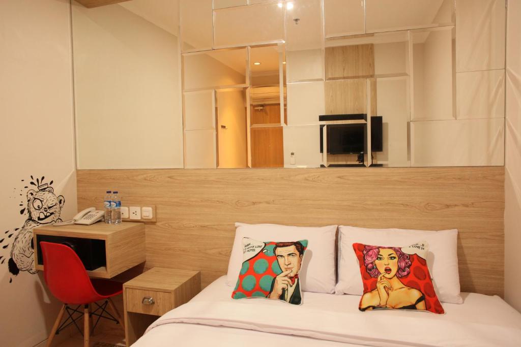 Postel nebo postele na pokoji v ubytování Bold Hotel Jakarta