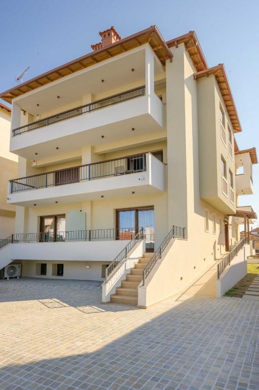 a building with stairs in front of it at Leon Apartments in Ierissos