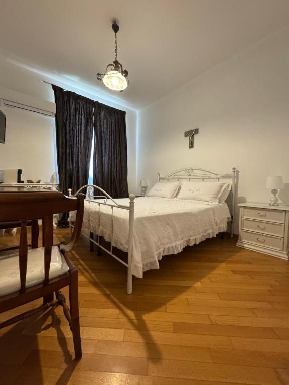 a bedroom with a white bed and a window at Villa Radiosa in Gravina in Puglia