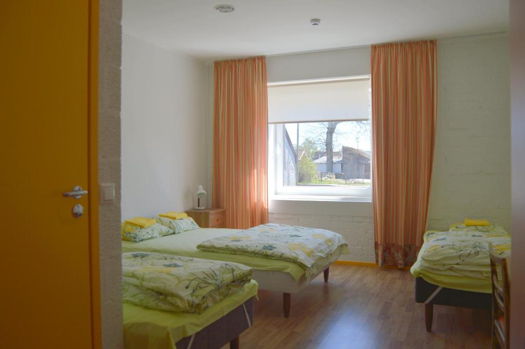 a bedroom with two beds and a window at Saare Automatic Hostel in Pärnu