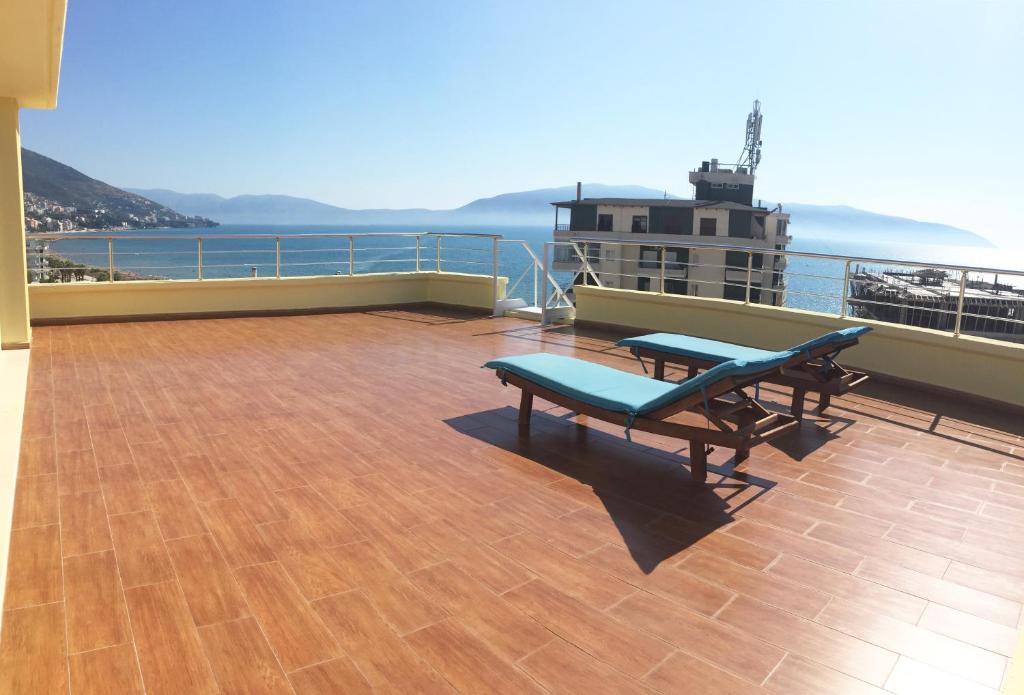 a balcony with two benches and a view of the ocean at Albi Guest House in Vlorë