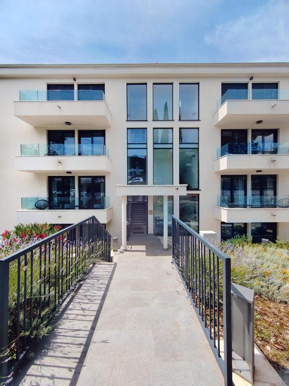 an apartment building with a walkway in front of it at Apartments Jadranka in Selce