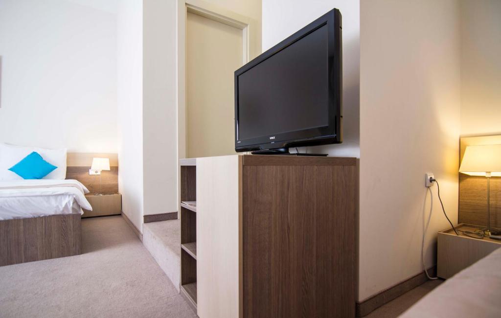 Postel nebo postele na pokoji v ubytování Apartments Legacy