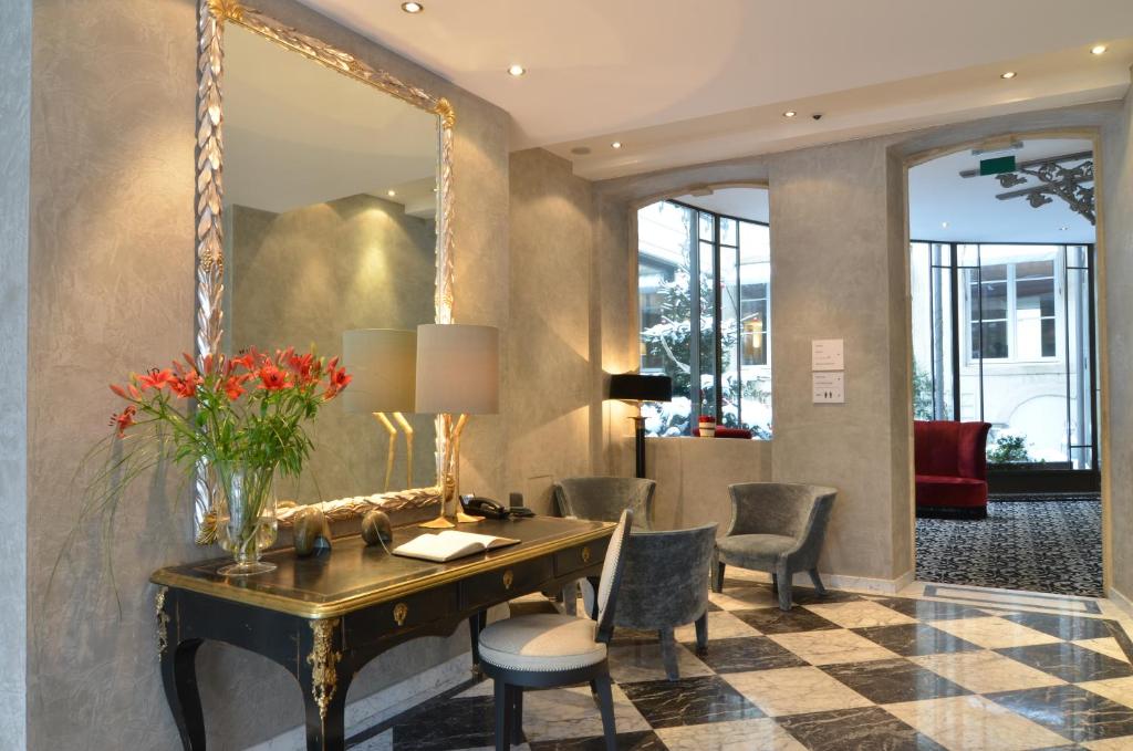 a dressing room with a desk and a mirror at Hotel Le Place d'Armes - Relais & Châteaux in Luxembourg