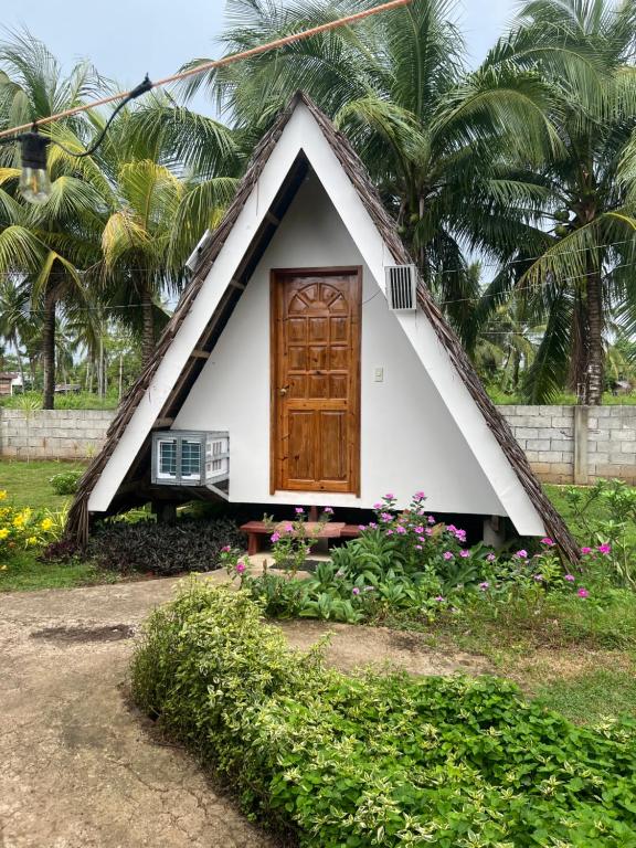 a small house with a triangular roof with a door at Fun Da House in San Juan