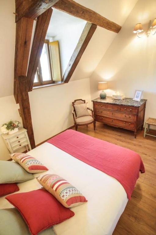 a bedroom with a large bed and a desk at La vie de château 2 in La Celle-sous-Gouzon