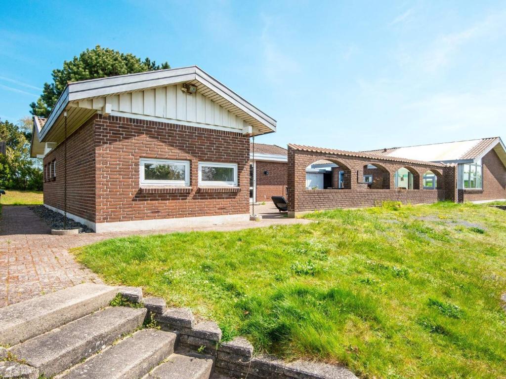 a brick house with a lawn in front of it at 8 person holiday home in Knebel-By Traum in Knebel