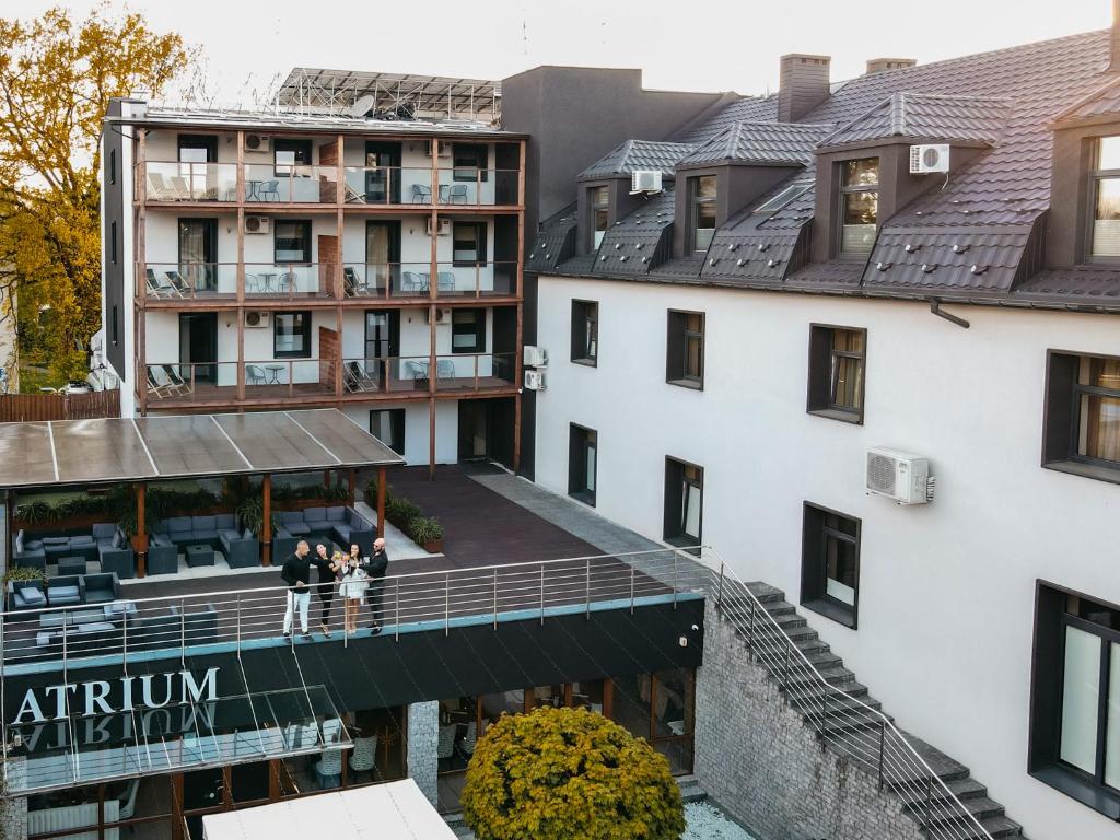 an aerial view of a building with people standing on a balcony at Hotel Senator Konferencje & SPA in Starachowice