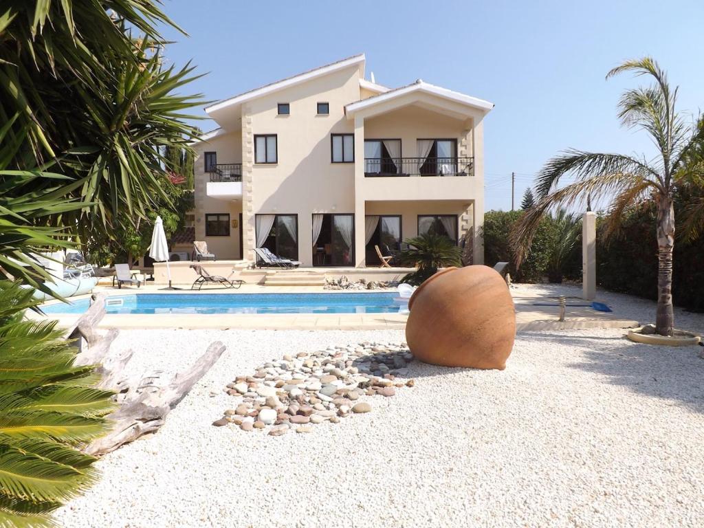 a villa with a swimming pool and a house at Villa Pelagia Secret Valley Paphos in Kouklia