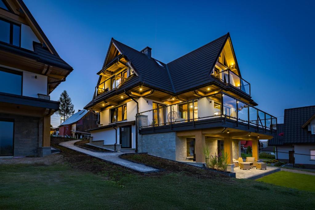 a large house with a black roof at Tatrzański Horyzont in Biały Dunajec
