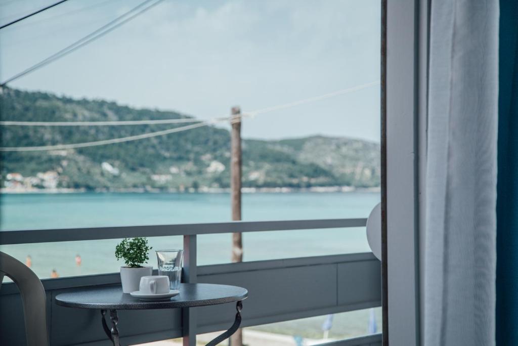 a balcony with a table and a view of the water at Anemi Beach in Skala Potamias