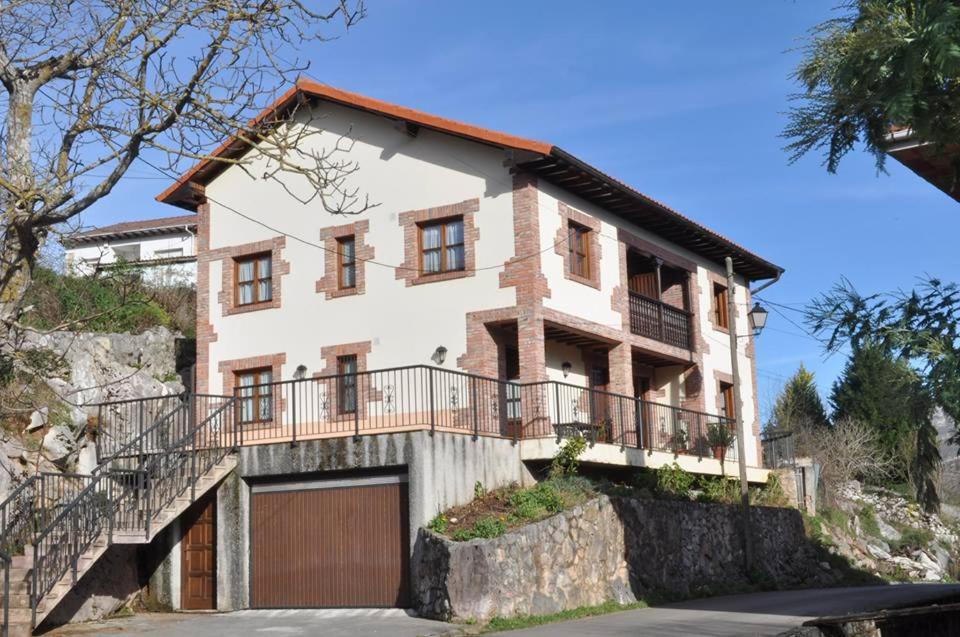 a house on a hill with a garage at Apartamentos La Huertina in Canales
