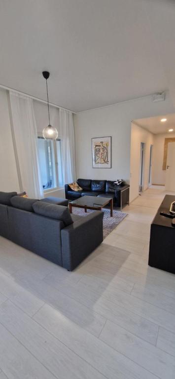 a living room with a couch and a table at Apartment in seaside Helsinki 83M2 with Sauna boat to Estonia 450 m from apartment in Helsinki