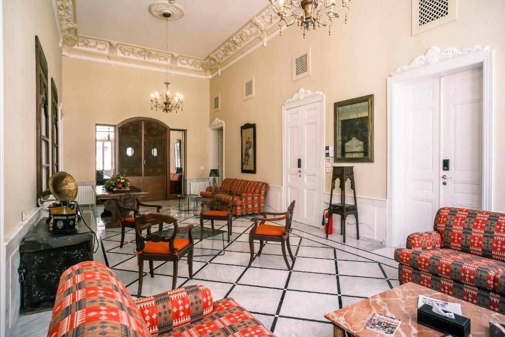 a living room with couches and a table at Beit Toureef - SARAYA HALA 'PALATIAL' in Beirut