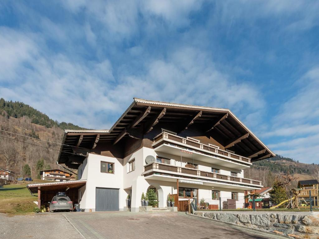 a large white building with a gambrel roof at Apartment in Bramberg near Ski Lift in Bramberg am Wildkogel