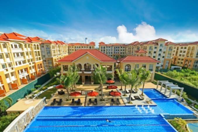 an aerial view of a resort with a swimming pool at CK Condotel at Sanremo Oasis in Cebu City