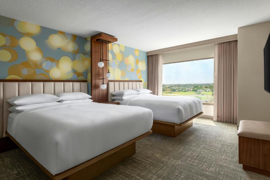 a hotel room with two beds and a window at Anaheim Marriott Suites in Anaheim