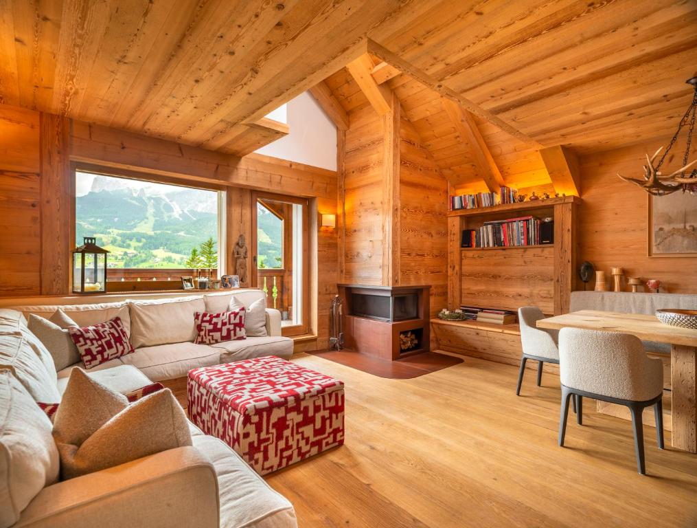 a living room with a couch and a table at Tablà del Bosco R&R in Cortina dʼAmpezzo