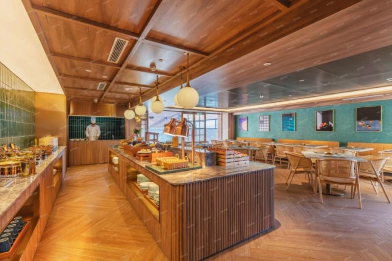 a restaurant with tables and chairs in a room at Orange Hotel, Zhongguancun University of Science and Technology in Beijing