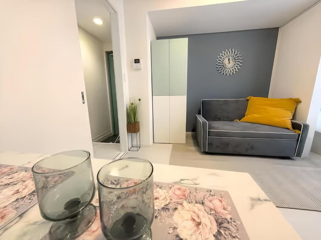 two wine glasses sitting on a table in a living room at 近藤ビル in Tokyo