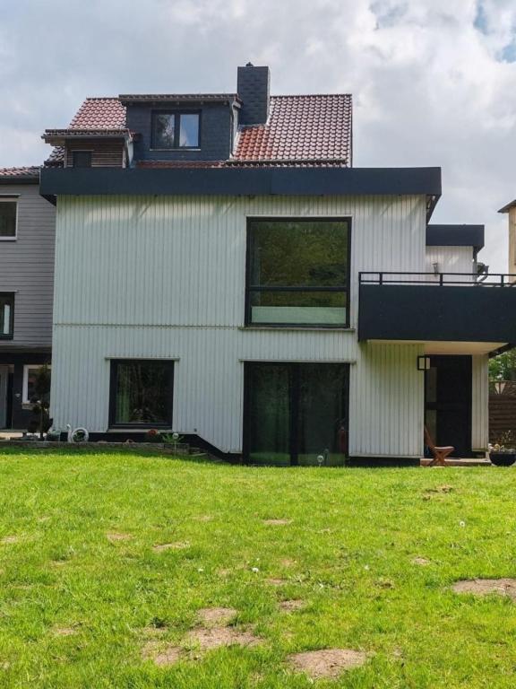 a house with a green lawn in front of it at RuDi Ferien Ressort in Hahnenklee-Bockswiese