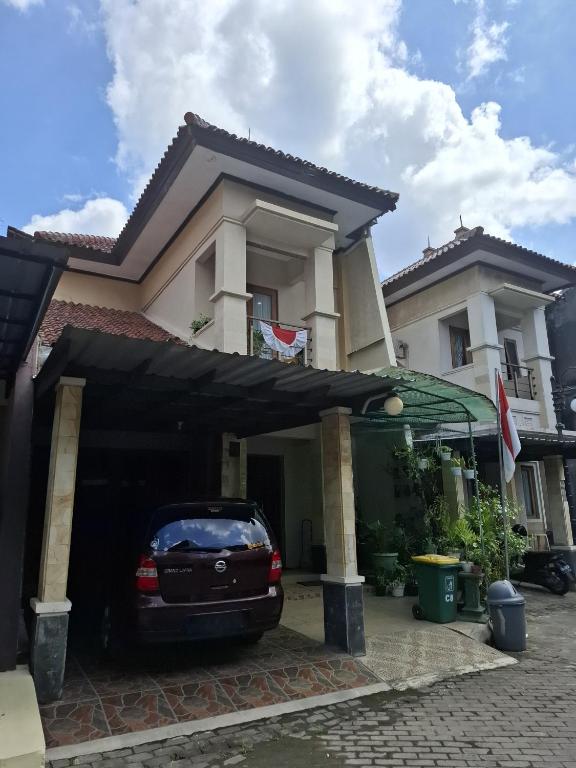 a car parked in the garage of a house at Rumah Bapak in Yogyakarta