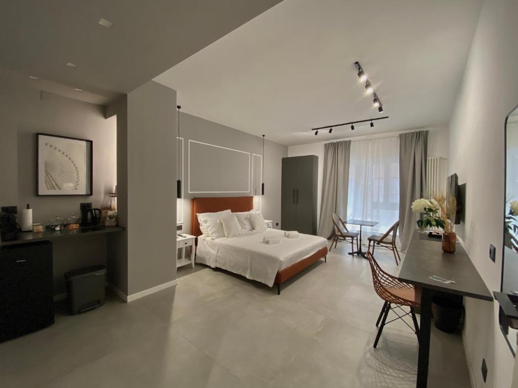 a bedroom with a bed and a table in it at Le Dimore del Centro in Bari