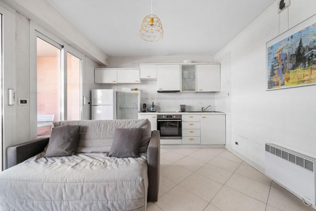 a living room with a couch in a kitchen at PALACIO- Centre-Ville - Parking privé - Proche Mer - Grande terrasse in Menton