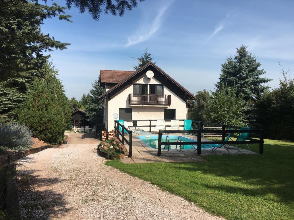 a house with a picnic table in front of it at Chalet in Levínská Ole near Giant Mountains in Levínská Olešnice