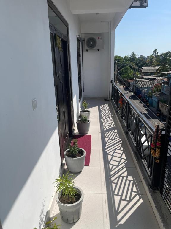 a balcony with potted plants on the side of a building at Blue Horizon Apartments in Trincomalee